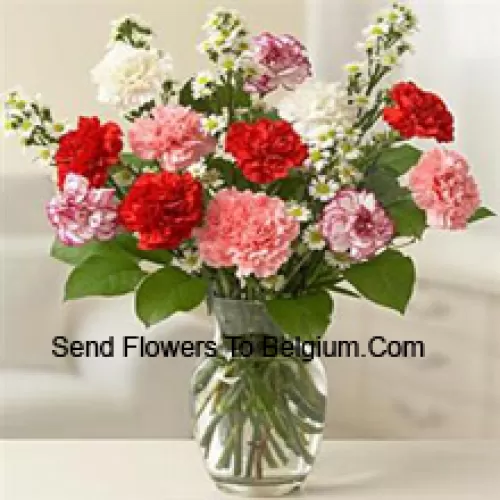 11 Mixed Colored Carnations With Some Ferns In A Glass Vase