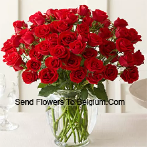 51 Red Roses With Some Ferns In A Glass Vase